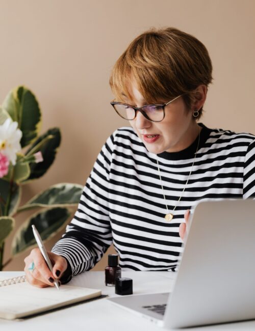 focused-woman-writing-notes-in-notebook-4467857